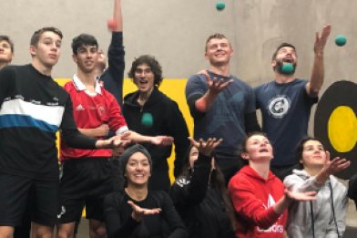 Gaelic Games Players in Cork Card Group of students playing with balls in a sports venue