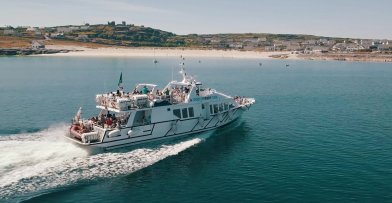 Doolin Ferry to Inis Oirr - AranIsland Ferry approaching Inis Oirr Pier on the East Coast of The Island. View of the castle on the horizon