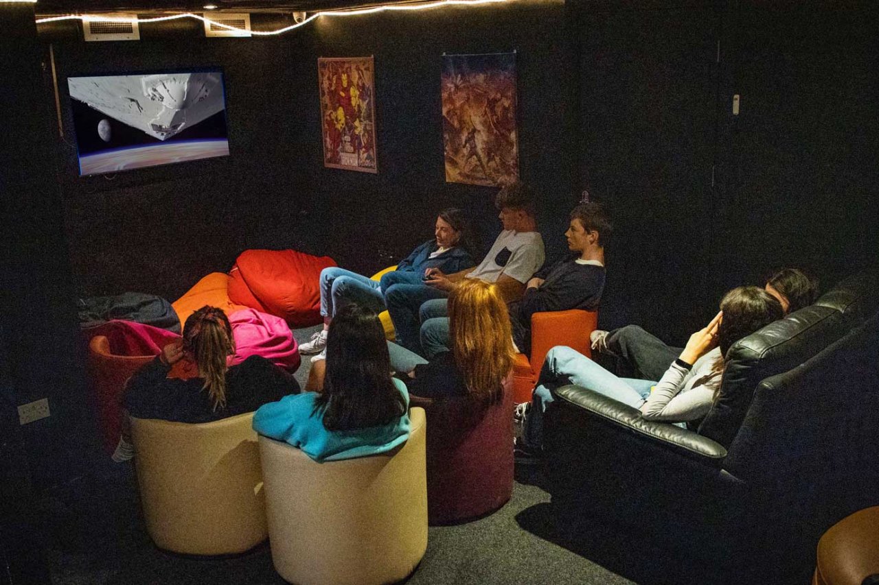 Movie Room in Sheilas Hostel Cork Students Watching Movie - Hostel Cinema Room