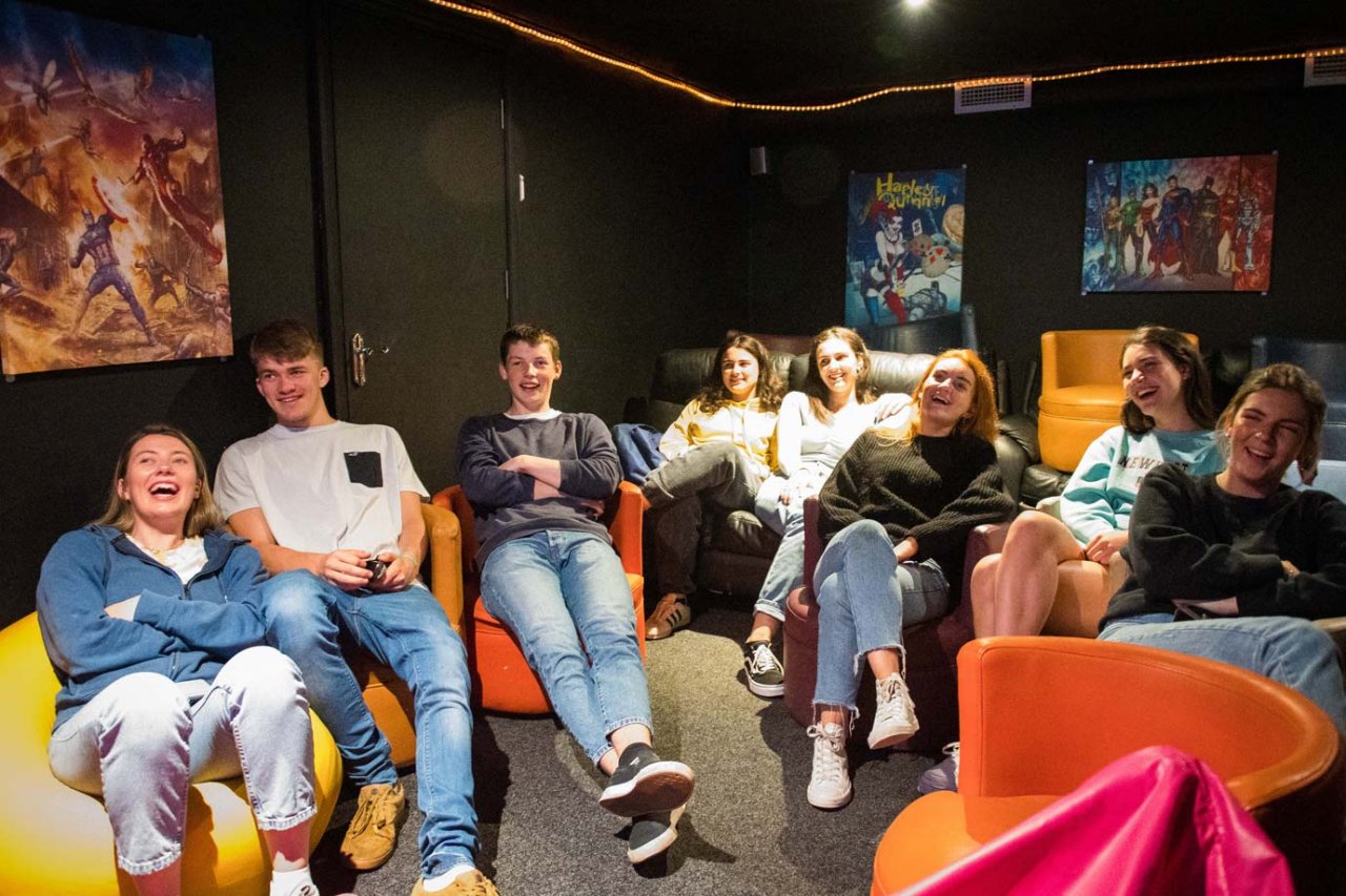 Cork City Sheilas Hostel - TV Room Group of Students in Cinema Room