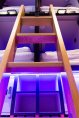 Pod Hostel Access Ladder Dublin Dock Central access ladder to upper capsules in pod hostel brightly lighted