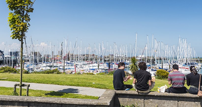 Groups Enjoying a Sunny Day in Howth Harbour Near Dublin Howth Yacht Marina - Sunny Day By The Coast