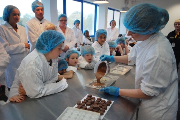 Group of tourists watching a chocolate making workshop