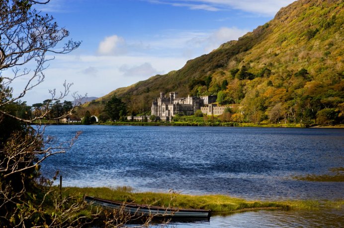View over Kylemore Abbey from the opposite side of the lake on a sunny day