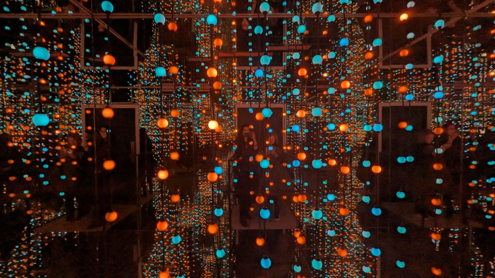 World of Illusion Infinity Room in Deep Blue in Dublin School visitors experiencing infinity room with multi-coloured light strings in mirrored room creating infinity effects for educational purposes